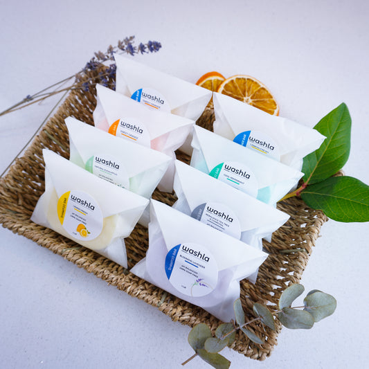 Wrapped Washla shampoo and conditioner bars in hamper tray with orange slices and dried lavender for decoration