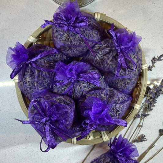 Basket filled with bundles of dried lavender sachets. Each sachet measuring 7x9cm.