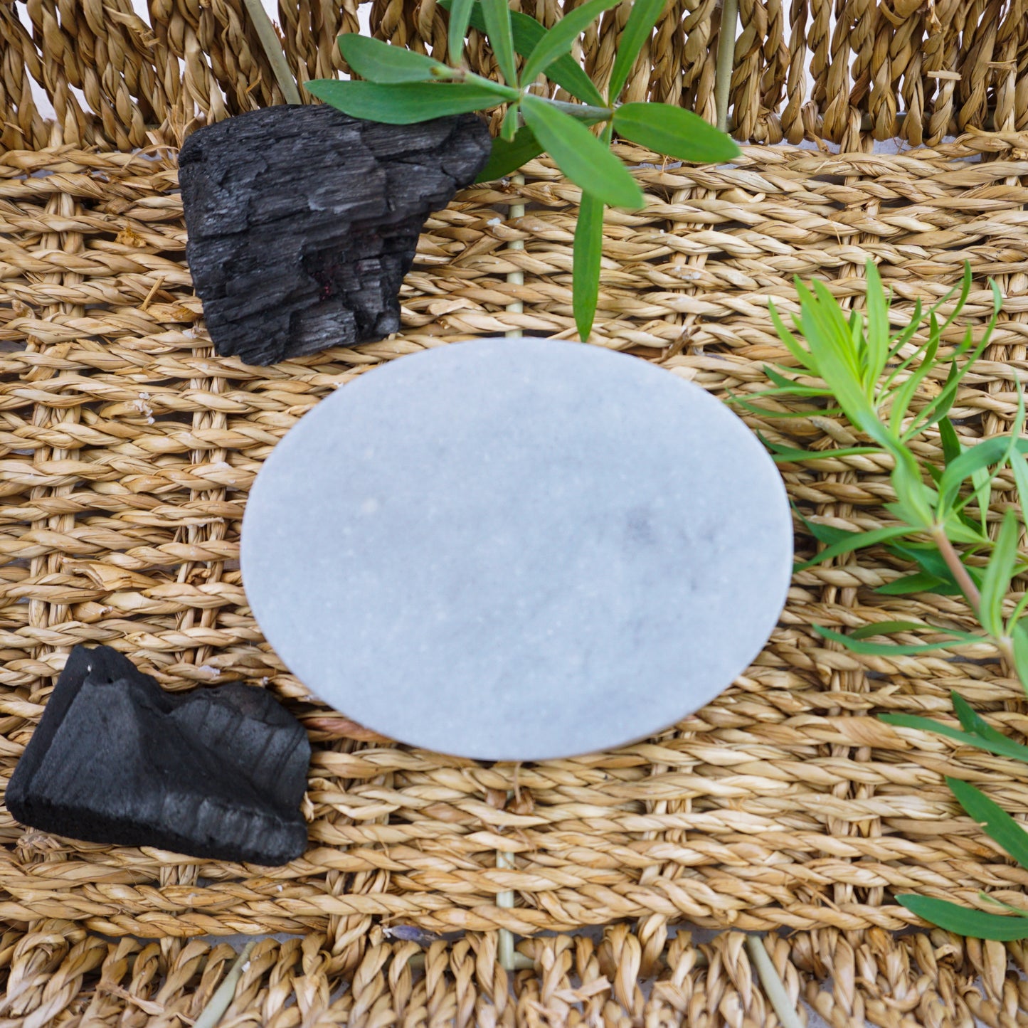 Washla 90g Teatree and charcoal shampoo bar on hamper tray. Shampoo bar is unwrapped