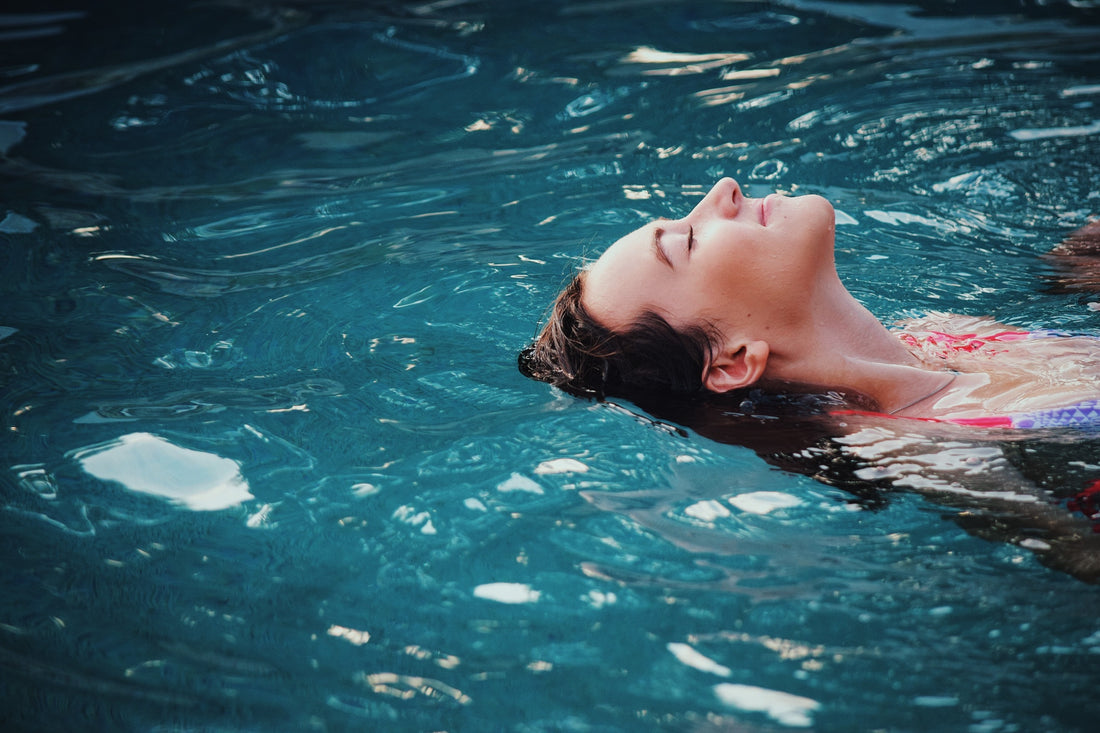A woman relaxing in a swimming pool
