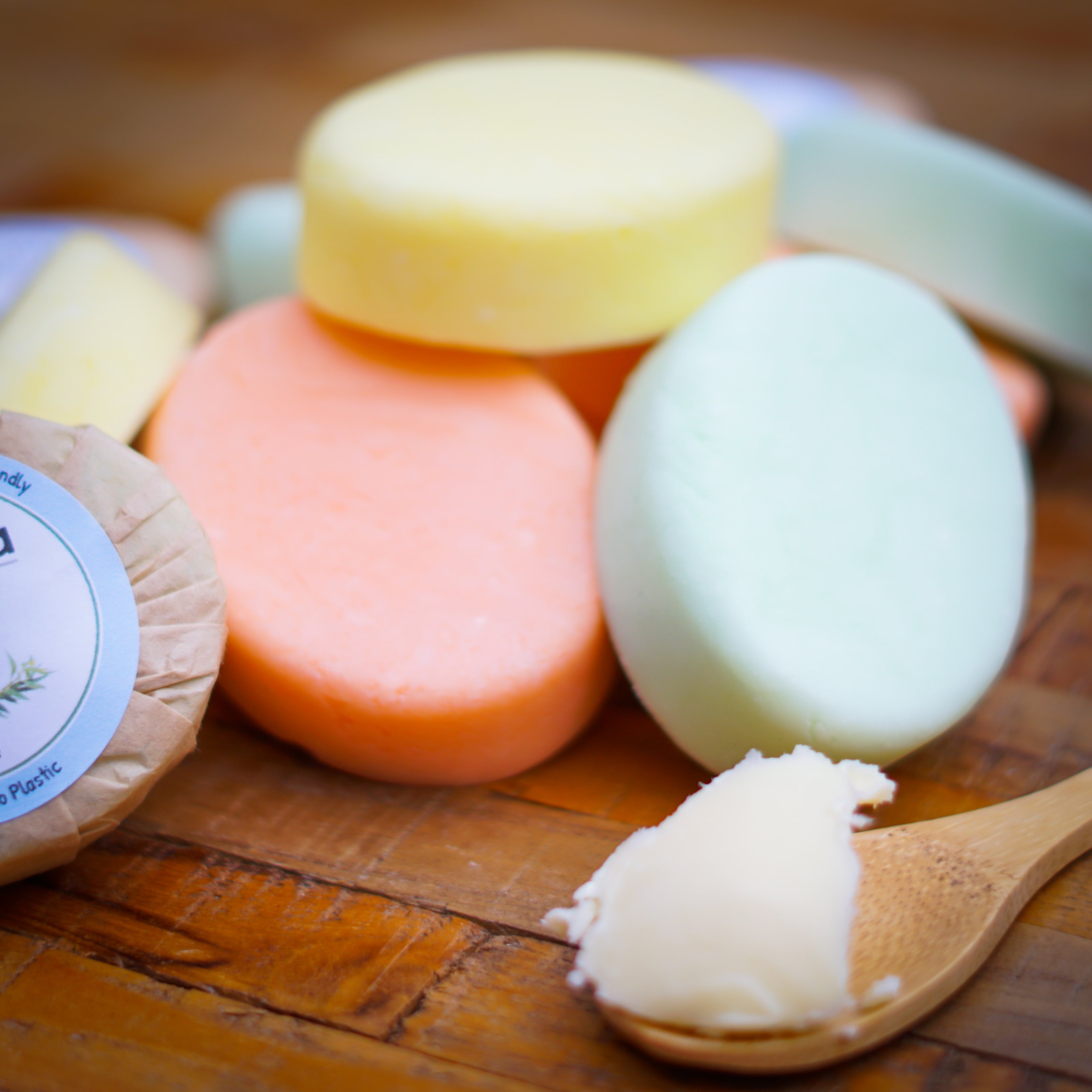 Hydrate shampoo bars with a wooden spoon of shea butter