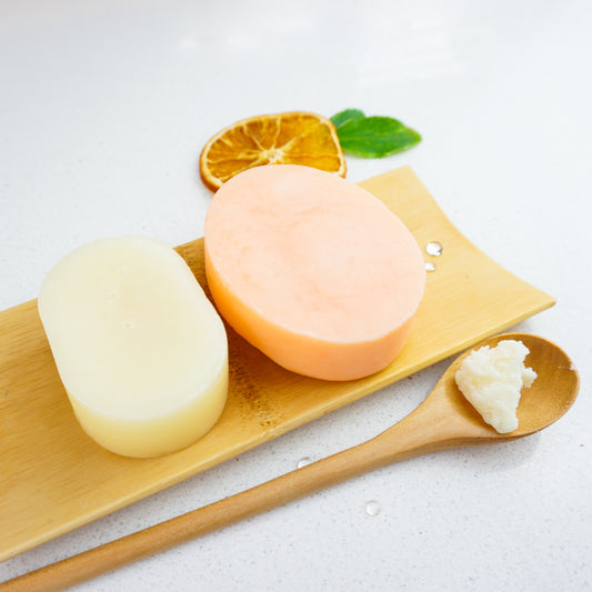 Sweet orange shampoo and conditioner bars with a spoonful of shea butter