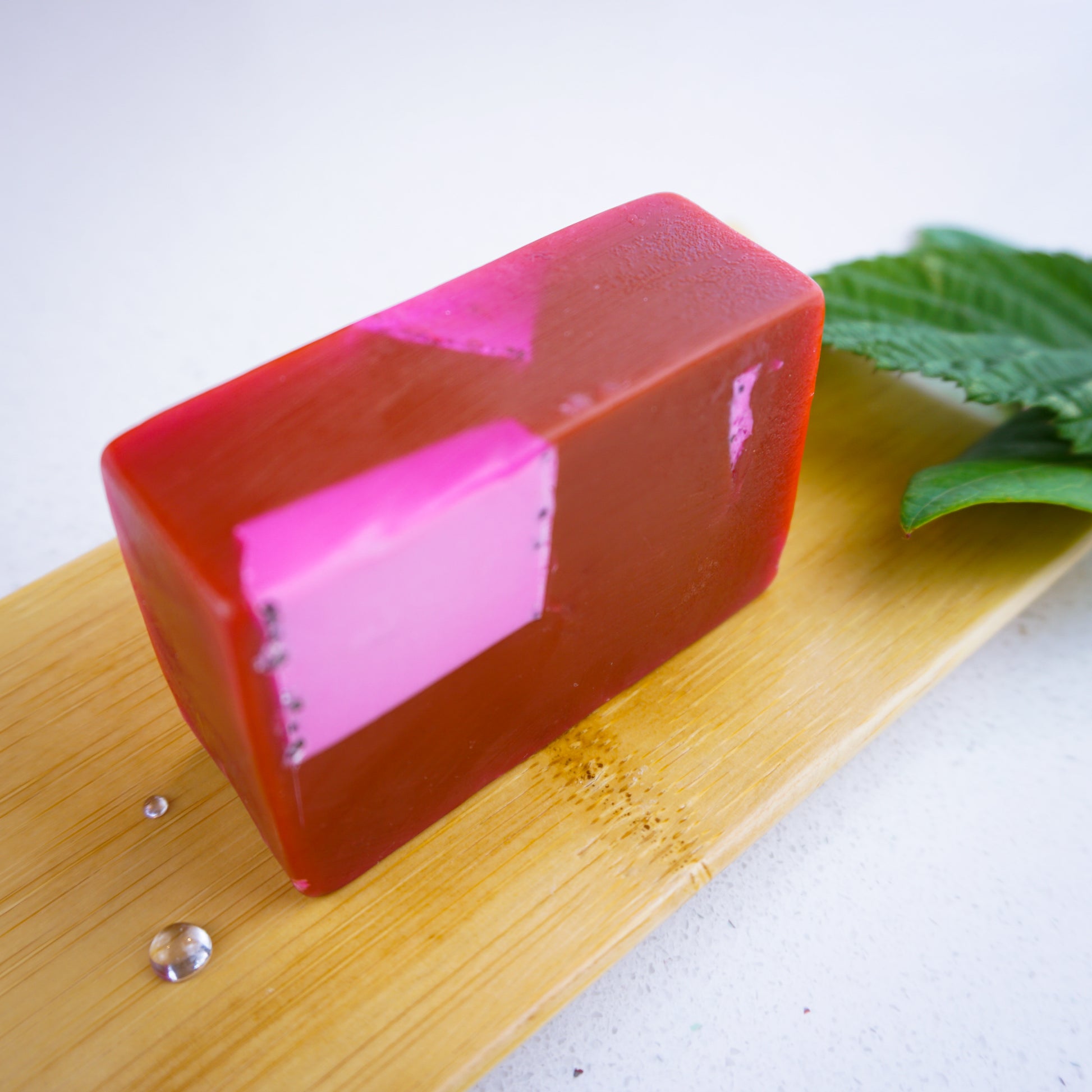 Black Raspberry and vanilla soap bar with water droplets sitting on bamboo tray