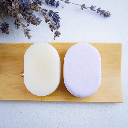lavender shampoo and conditioner bars on bamboo tray