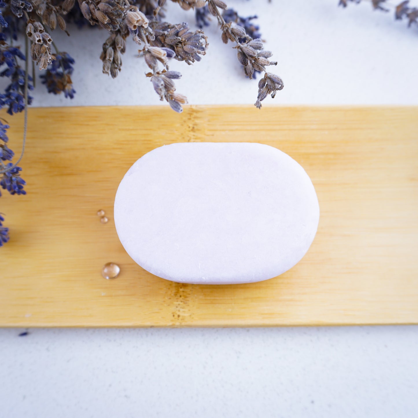 Washla Lavender 60g Shampoo bar on bamboo tray with dried lavender surrounding it
