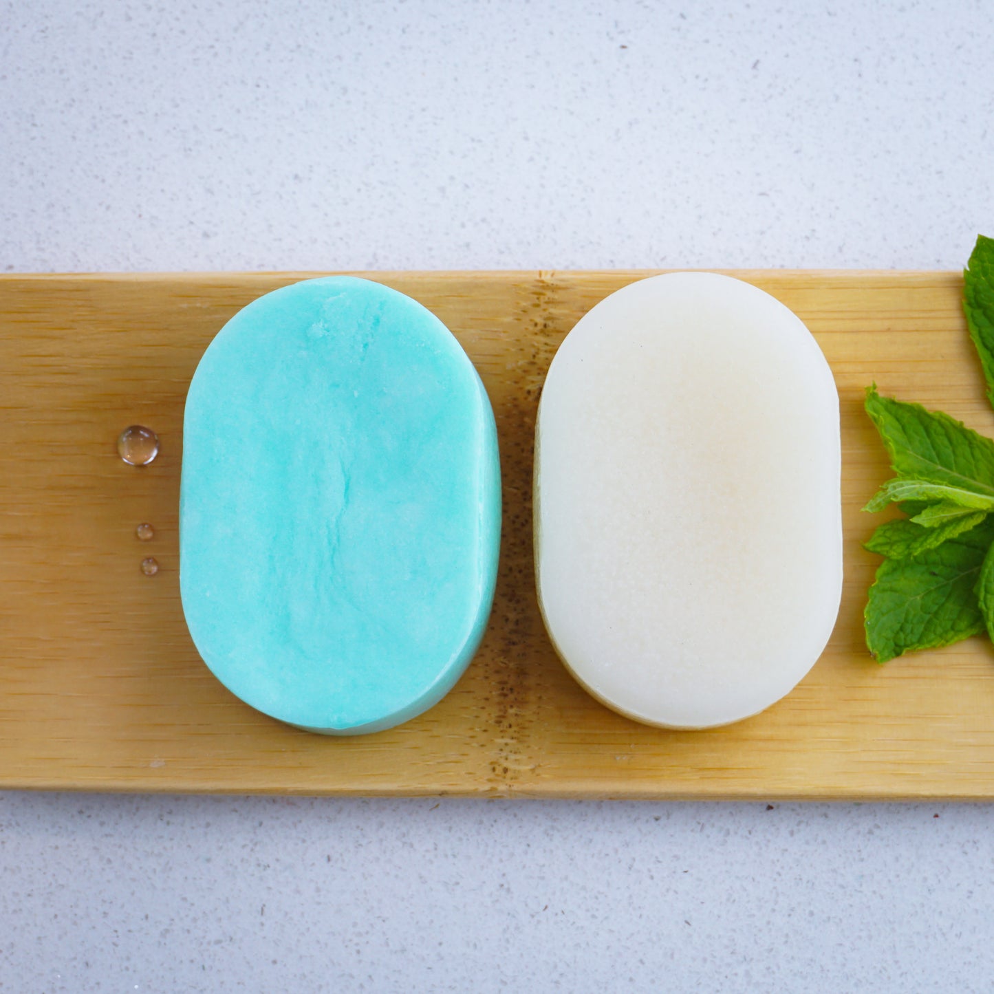 peppermint shampoo bar with peppermint conditioner bar on bamboo tray