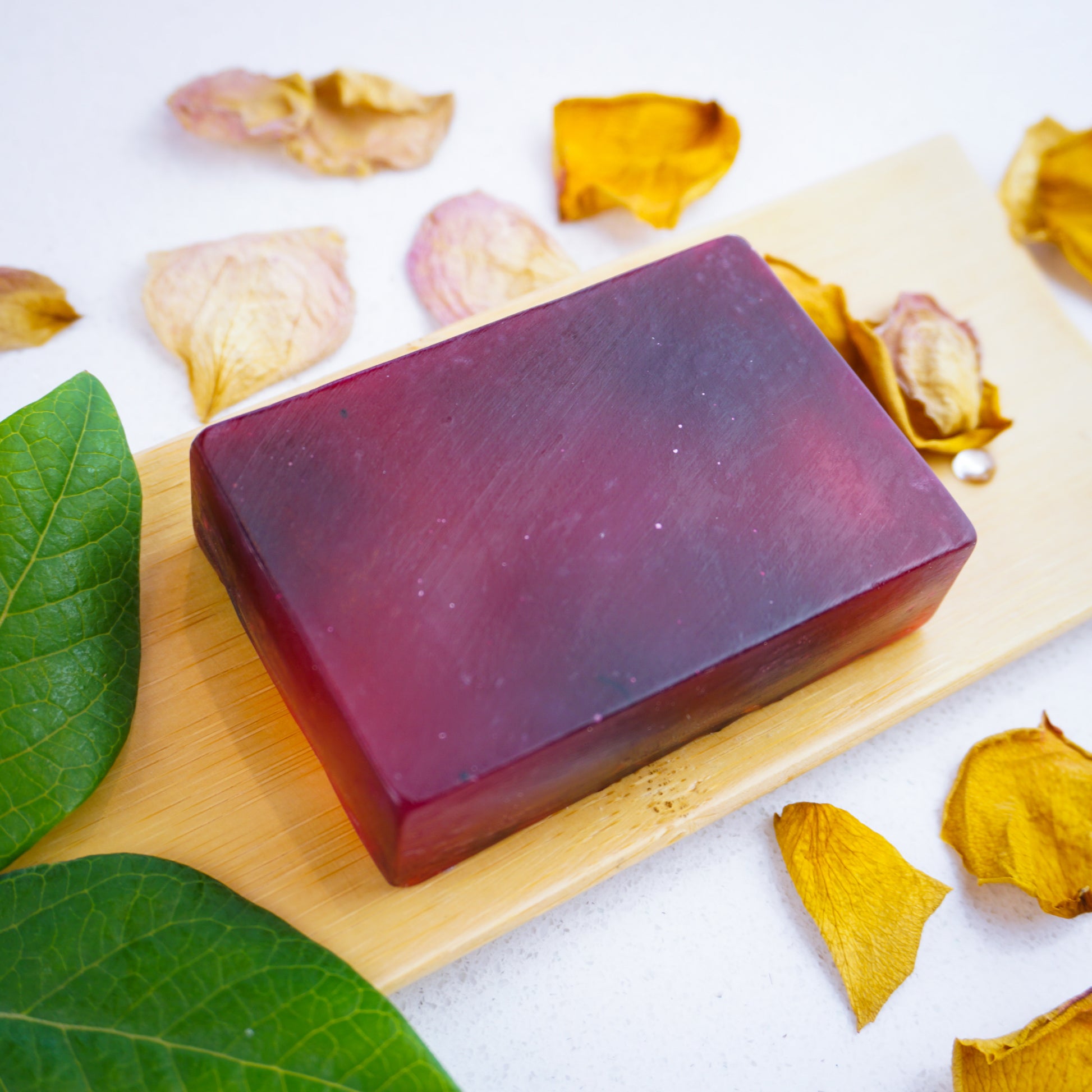 Rose & Ylang Soap Bar surrounded by dried yellow rose petals