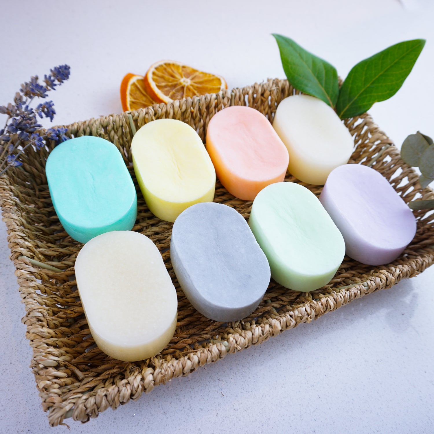 shampoo and conditioner bars sitting on a bamboo tray
