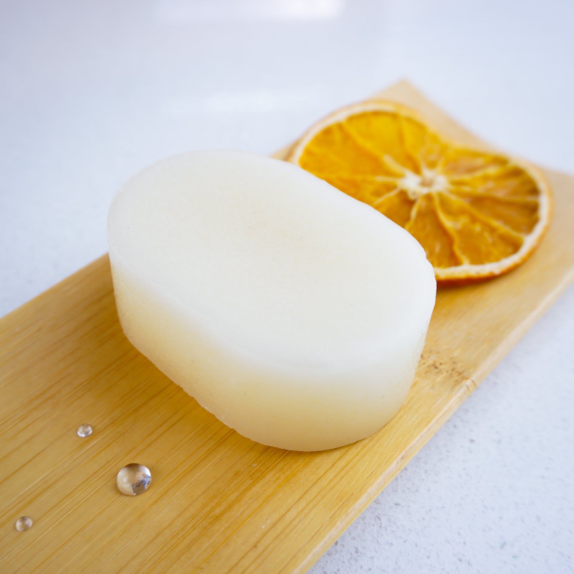 orange conditioner bar on bamboo tray