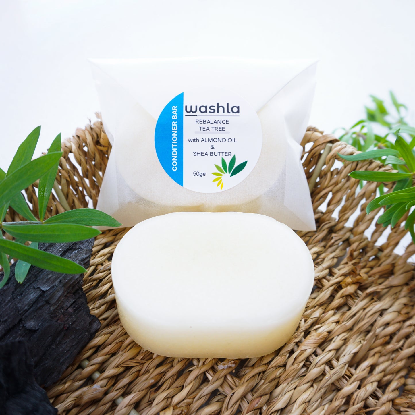 tea tree conditioner bar wrapped sitting on a hamper